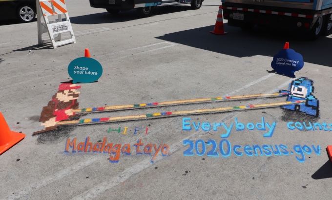 Census chalk art at an outreach event.