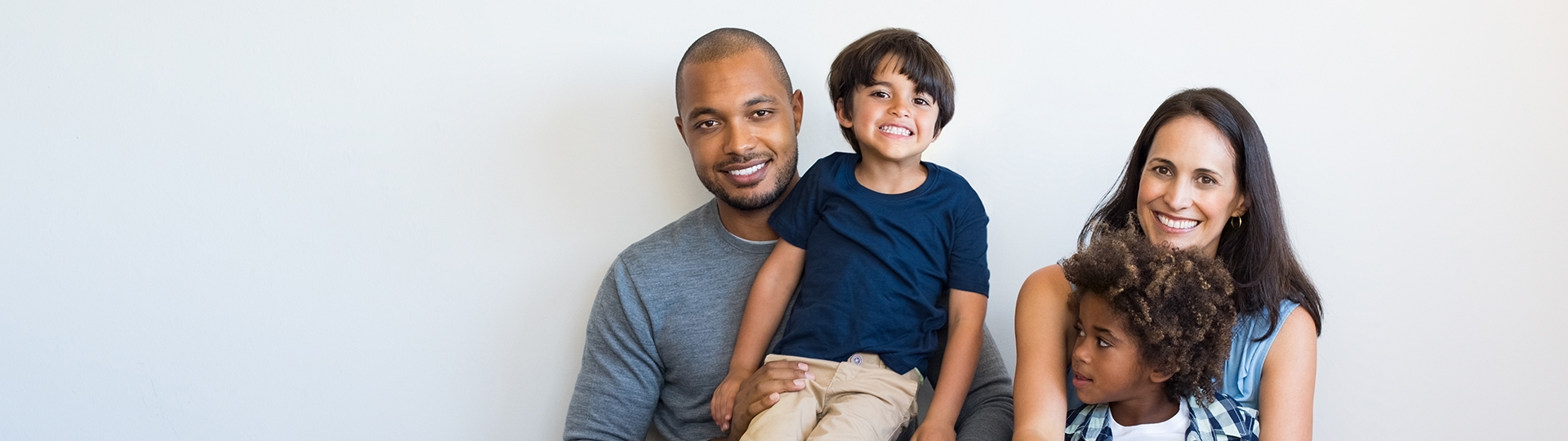 Banner of a diverse family of four (a man, a woman and two children).